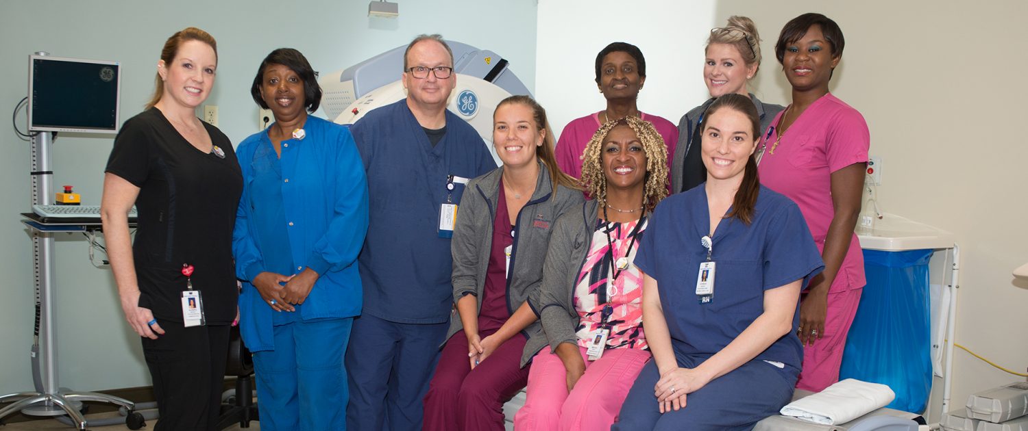 a group of smiling physicians